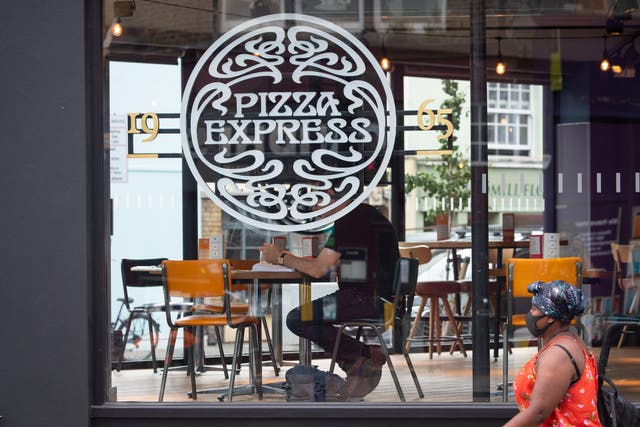 A woman passes a branch of Pizza Express in London, as the restaurant chain announced the appointed of new boss Paula MacKenzie (Dominic Lipinski/PA)