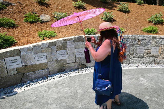 <p>A school teacher at the memorial for the Salem witches </p>