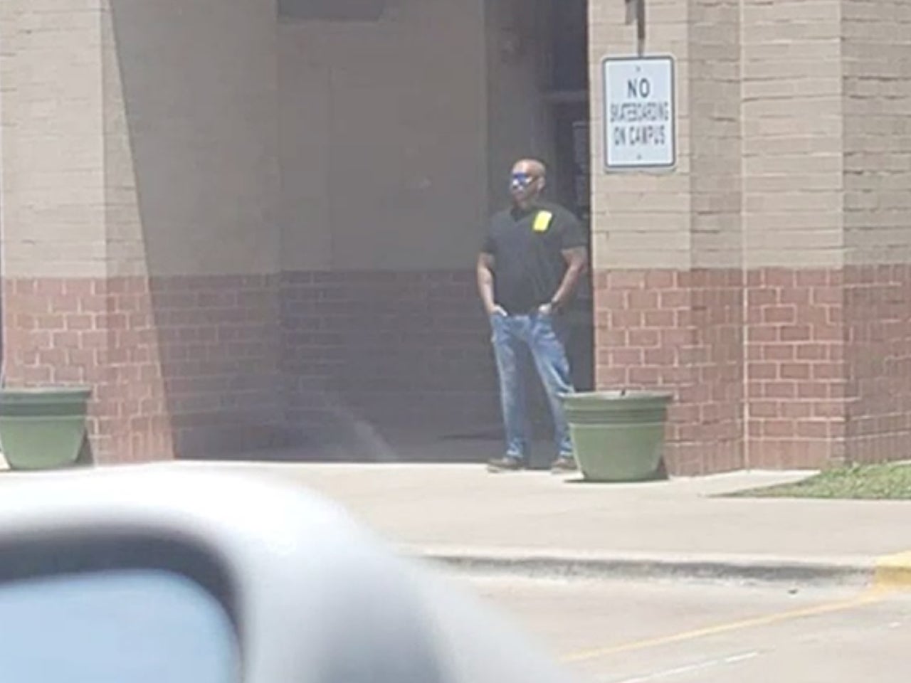 <p>Ed Chelby standing watch outside his daughter’s school in Killeen, Texas</p>