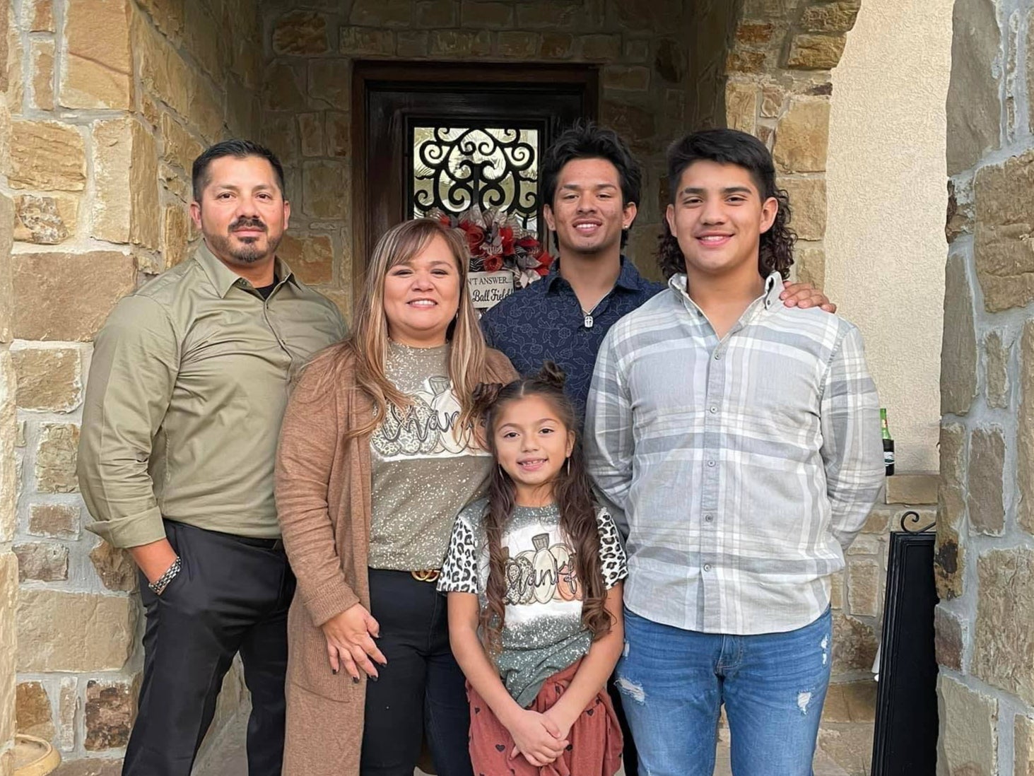 A picture of Jacob Alabarado, a CBP officer, and his family