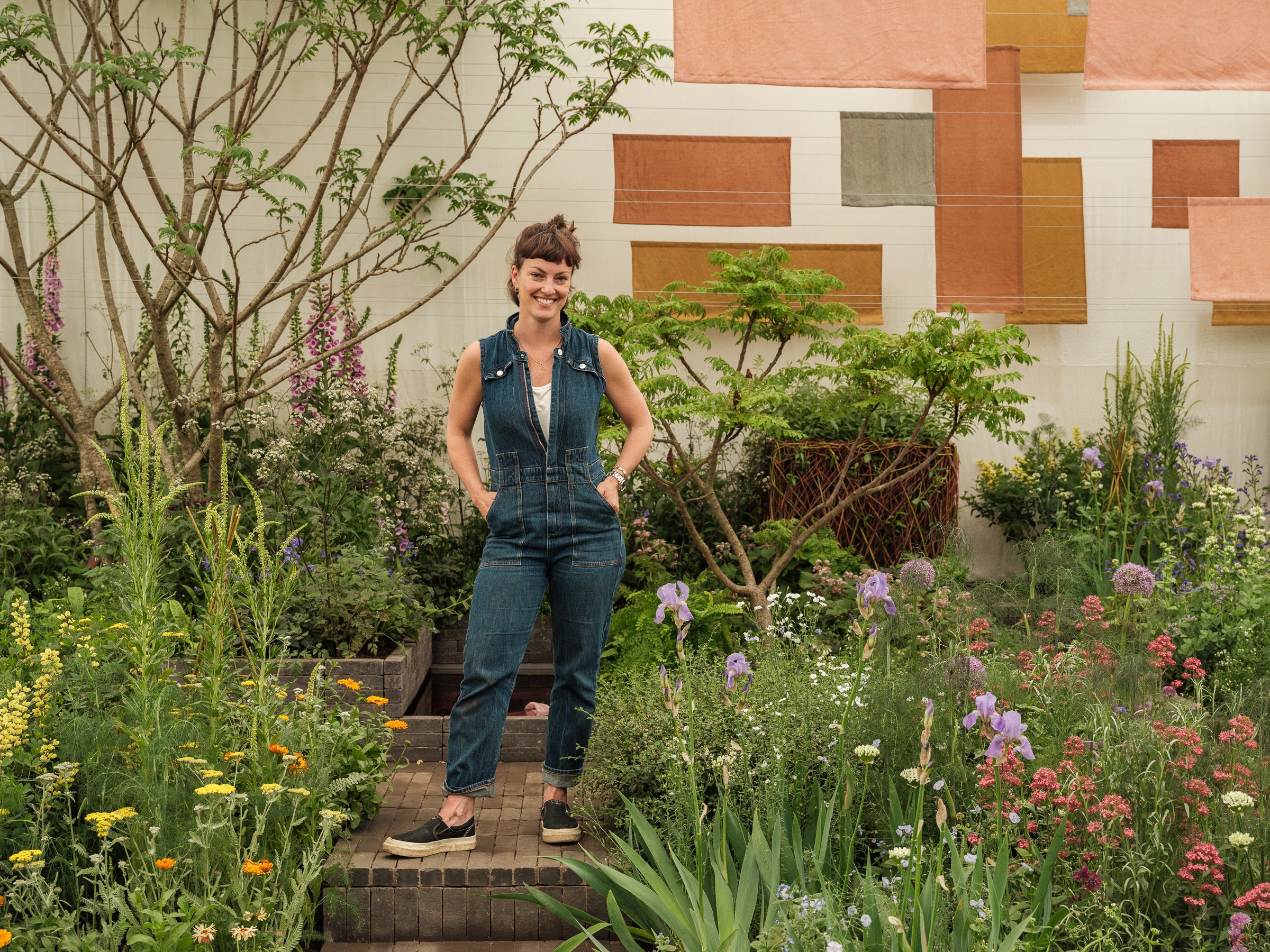 <p>Horticulturalist Lottie Delamain in her garden at Chelsea Flower Show</p>