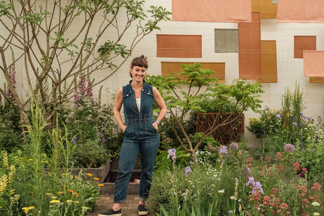 <p>Horticulturalist Lottie Delamain in her garden at Chelsea Flower Show</p>