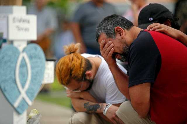 <p>Vincent Salazar, right, father of Layla Salazar, weeps while kneeling in front of a cross with his daughter’s name at a memorial site for the victims killed in this week’s elementary school shooting in Uvalde, Texas, Friday, May 27, 2022.</p>