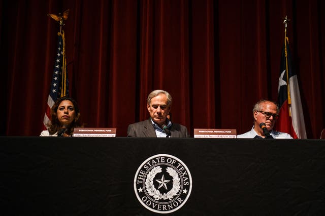 <p>Judicial District Attorney Christina Mitchell Busbee, Texas Governor Greg Abbott and mayor of Uvalde Don McLaughlin look on during a press conference in Uvalde, Texas on 27 May 2022</p>