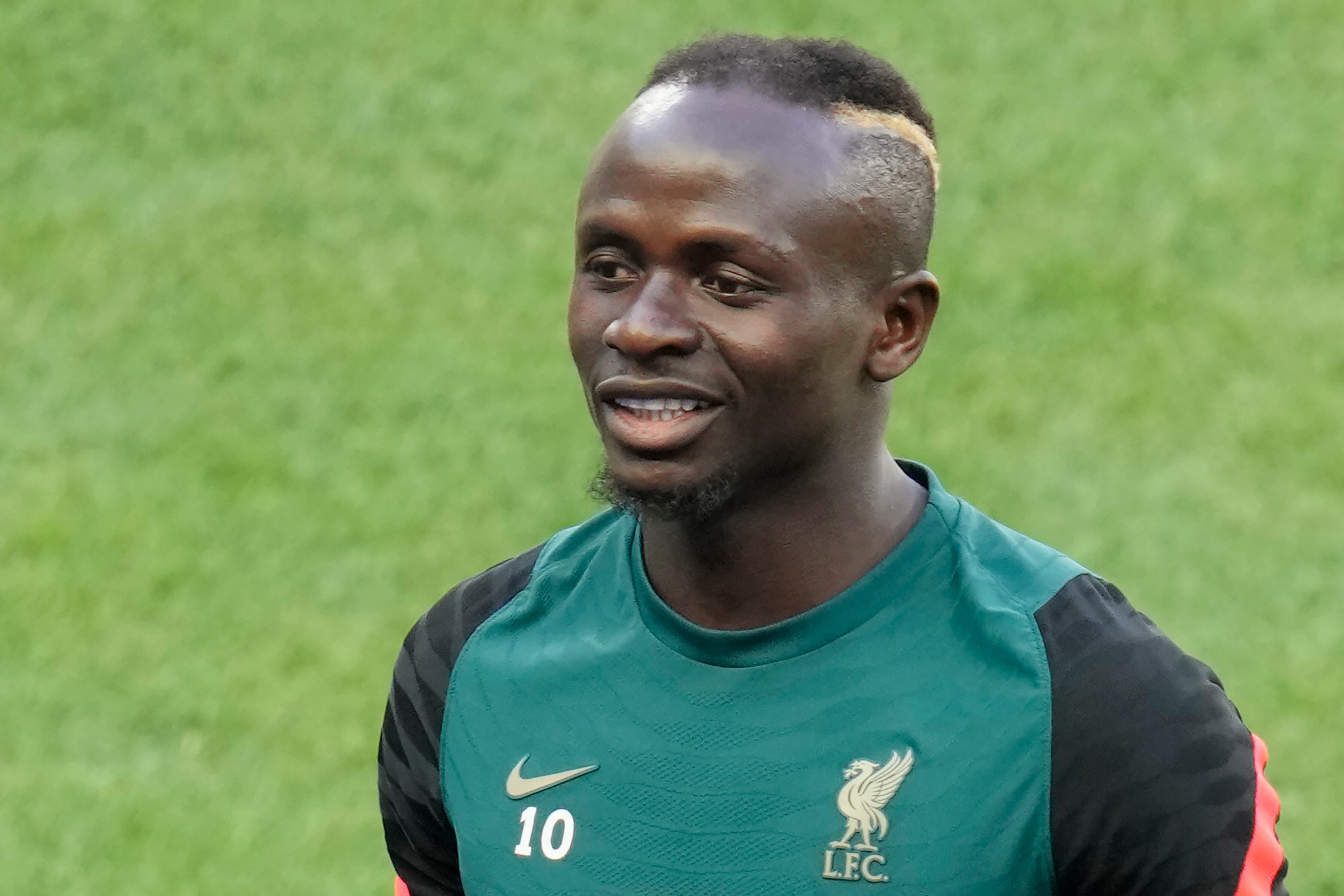 Sadio Mane smiles during a training session