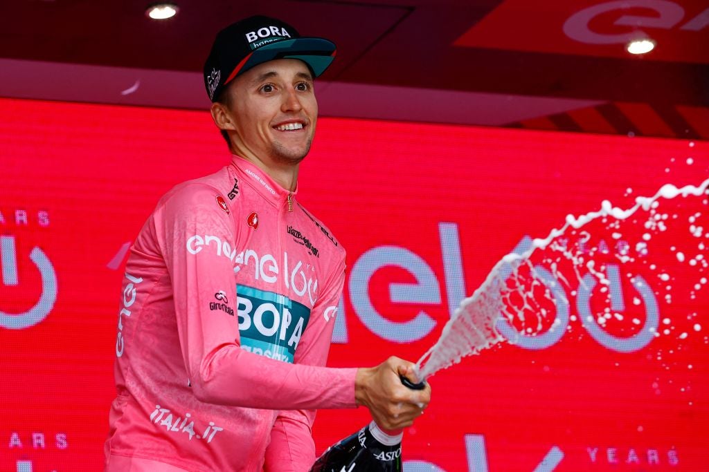 Jai Hindley celebrates on the podium after the 20th stage of the Giro d'Italia