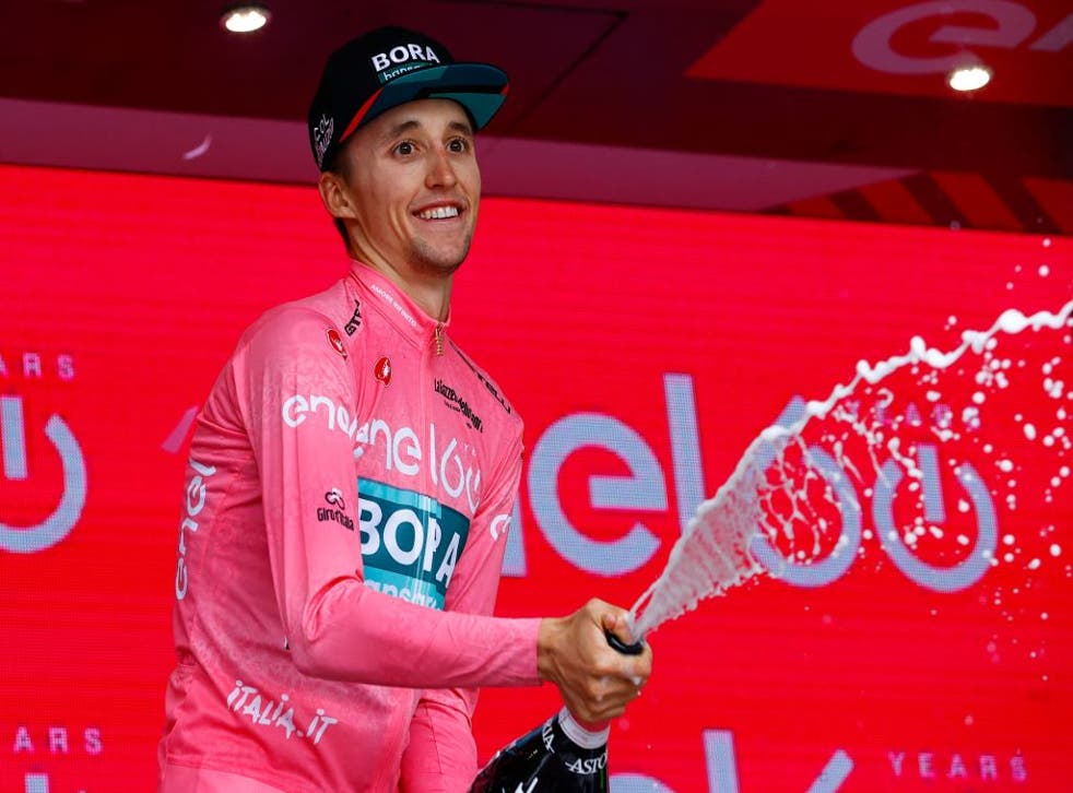 <p>Jai Hindley celebrates on the podium after the 20th stage of the Giro d'Italia </p>