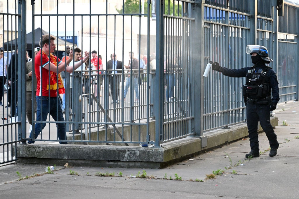 Police spray tear gas at Liverpool fans outside the stadium prior to the UEFA Champions League final match between Liverpool FC and Real Madrid at Stade de France
