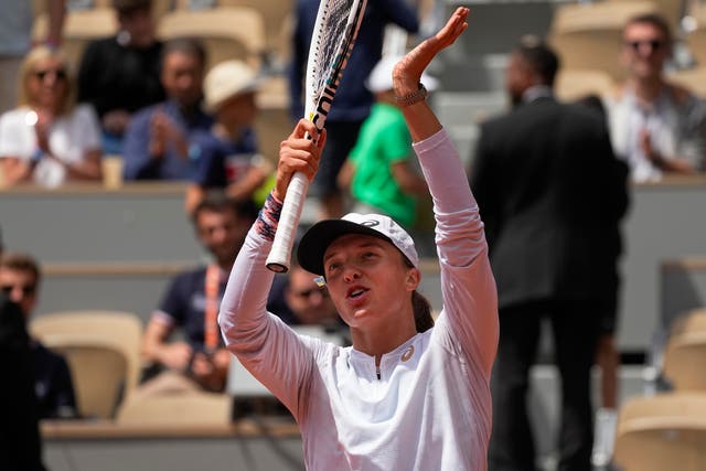 Iga Swiatek celebrates winning her match against Danka Kovinic (Michel Euler/AP)