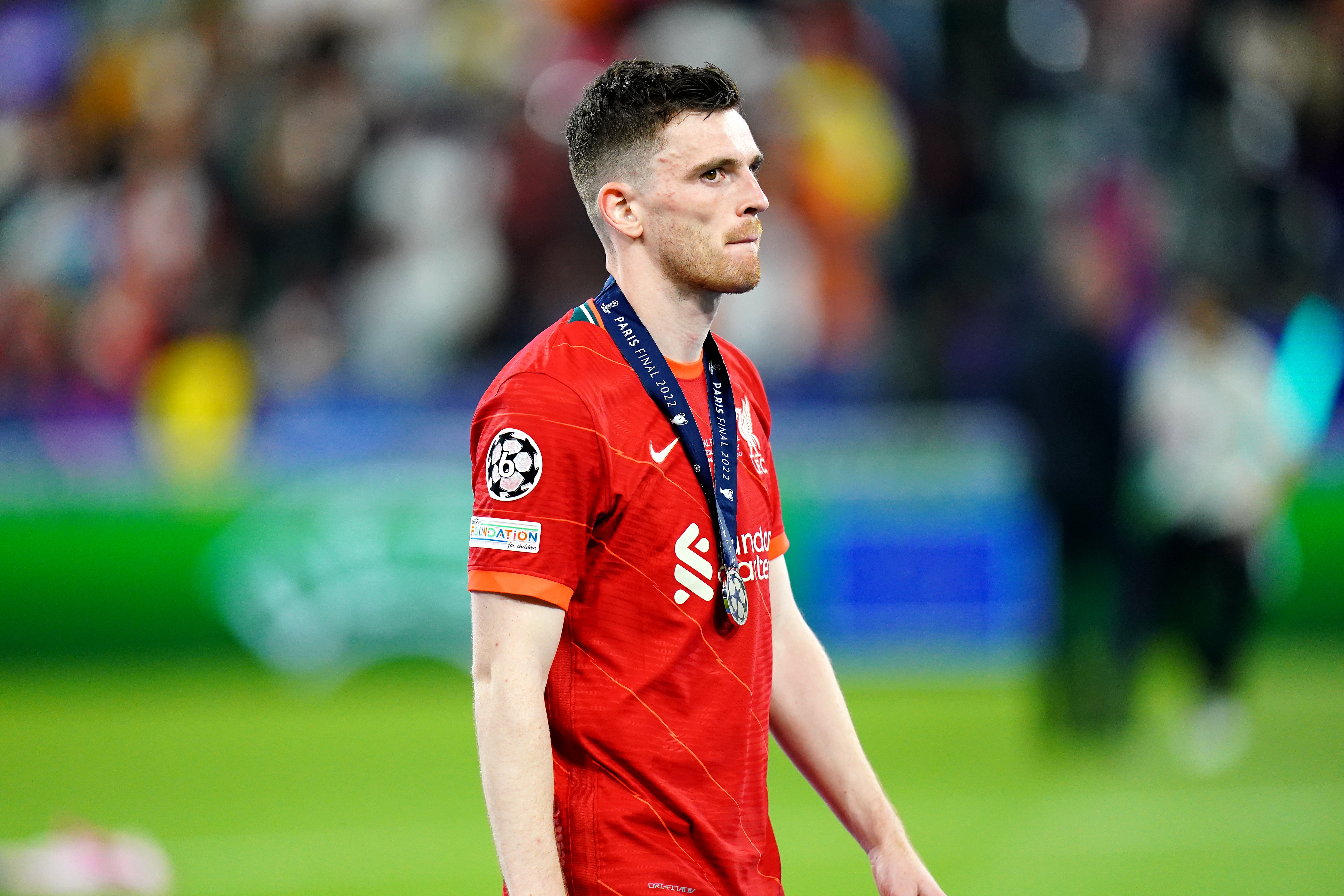 Andy Robertson walk away after collecting his runner-up medal