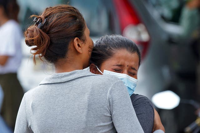 <p>Family members and relatives of passengers on board the Twin Otter aircraft operated by Tara Air, weep outside the airport in Pokhara on 29 May </p>