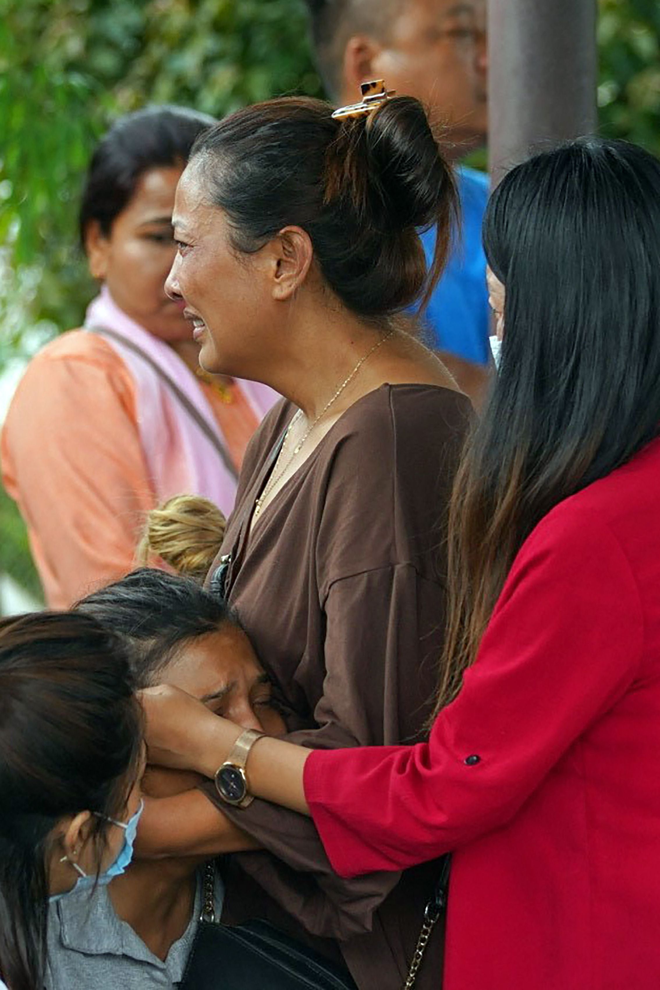 Family members and relatives of passengers on board the Twin Otter aircraft operated by Tara Air weep outside the airport in Pokhara