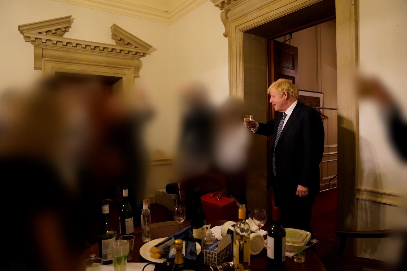 Photographs of Boris Johnson drinking at a staff leaving do were published as part of Sue Gray’s report into lockdown parties (Sue Gray Report/Cabinet Office/PA)