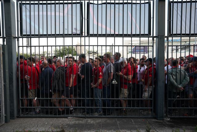 Fans gathered at the perimeter of the Stade de France ahead of the Champions League final in Paris (Nick Potts/PA)