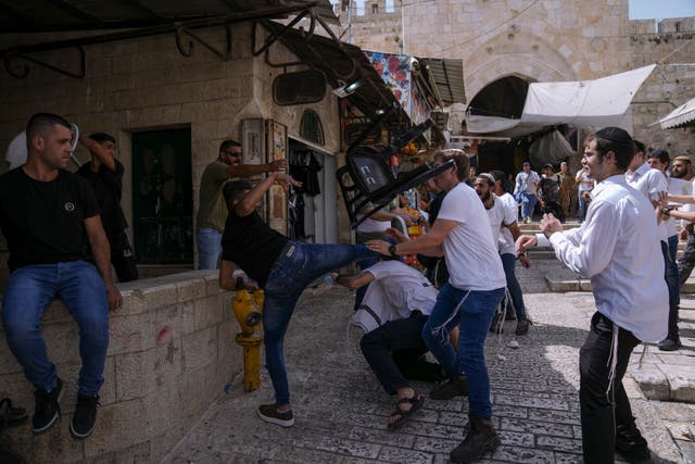 <p>Palestinians and Jewish youths clash in Jerusalem’s Old City as Israelis mark Jerusalem Day on 29 May </p>