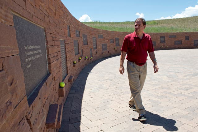 <p>Tom Mauser, wearing his son Daniel's shoes, walks along a wall of the Columbine High School Memorial July 22, 2012 in Littleton, Colorado. Mauser, the father of Columbine High school shooting victim Daniel Mauser, has become an activist for increased gun control. </p>