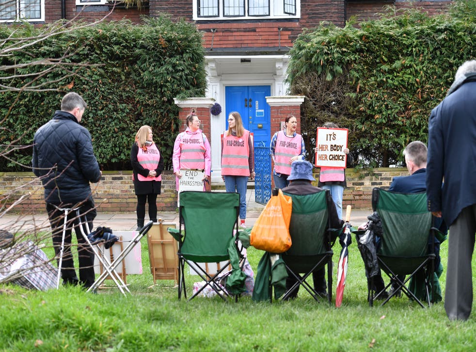 Pro-choice demonstrators (back) and anti-abortion demonstrators (foreground) gather outside a Marie Stopes clinic in London (John Stillwell/PA)