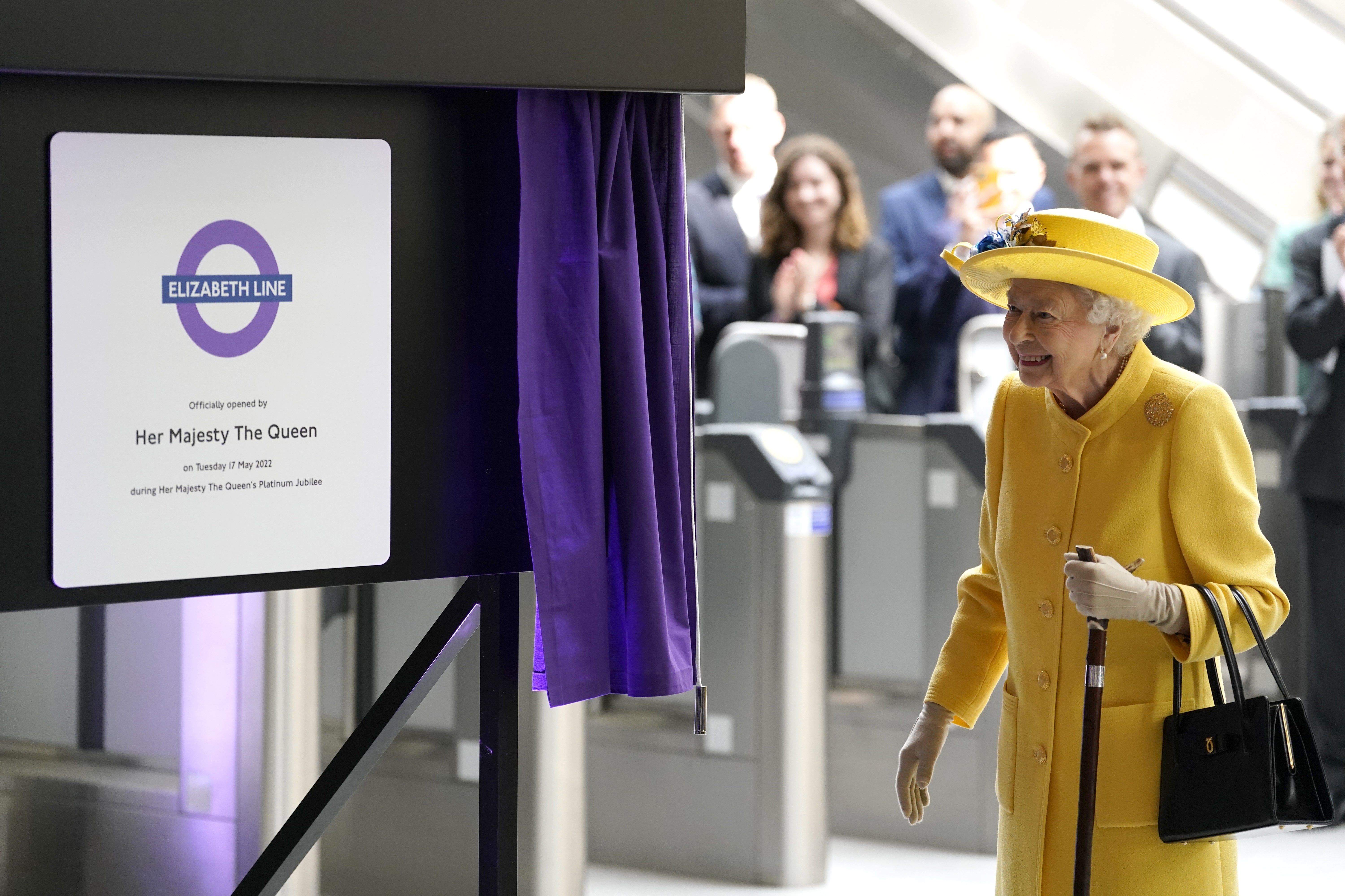 Queen Elizabeth II unveils a plaque to mark the Elizabeth line’s official opening at Paddington station in London (Andrew Matthews/PA)