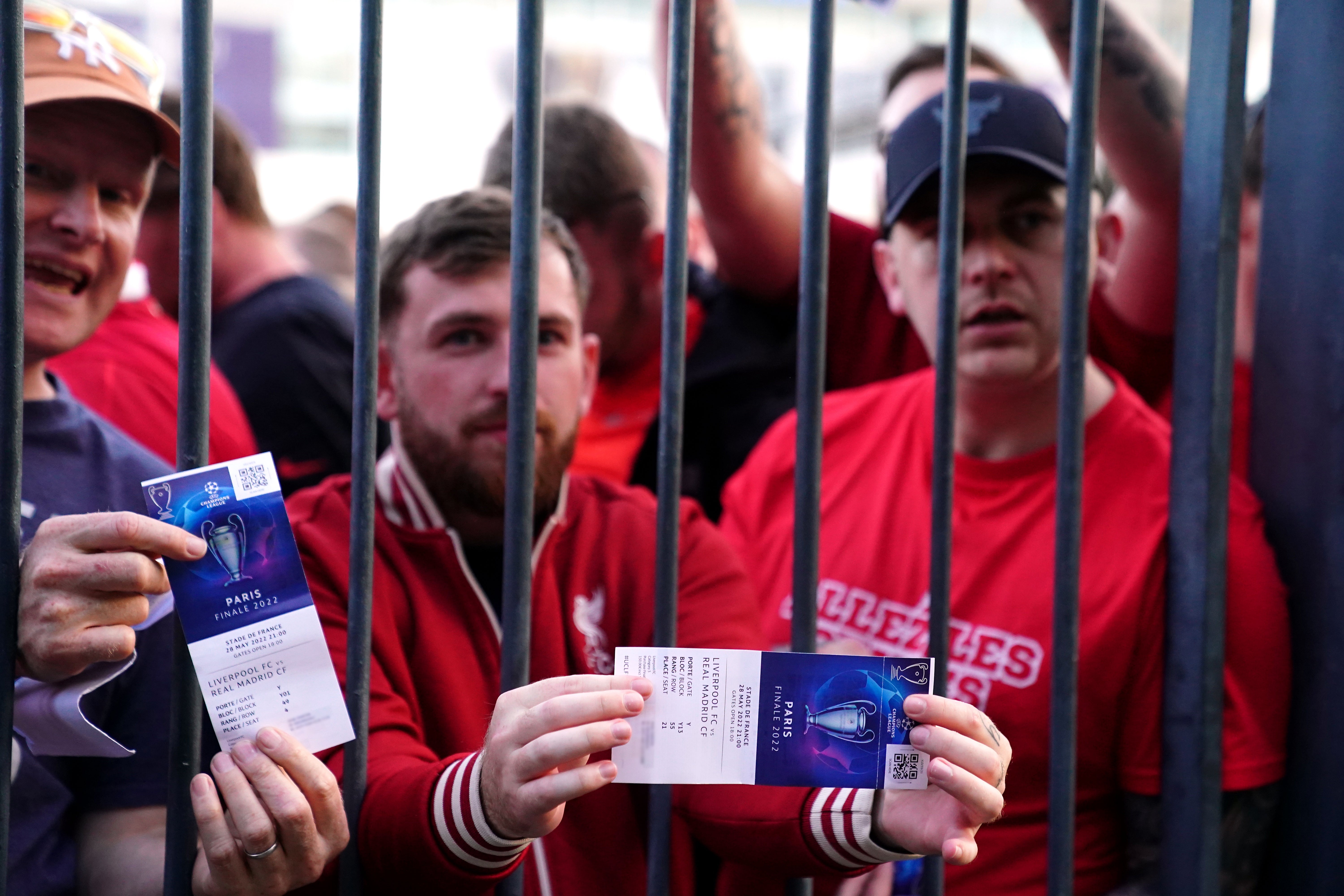 Liverpool fans stuck outside the stadium show their match tickets (Adam Davy/PA)