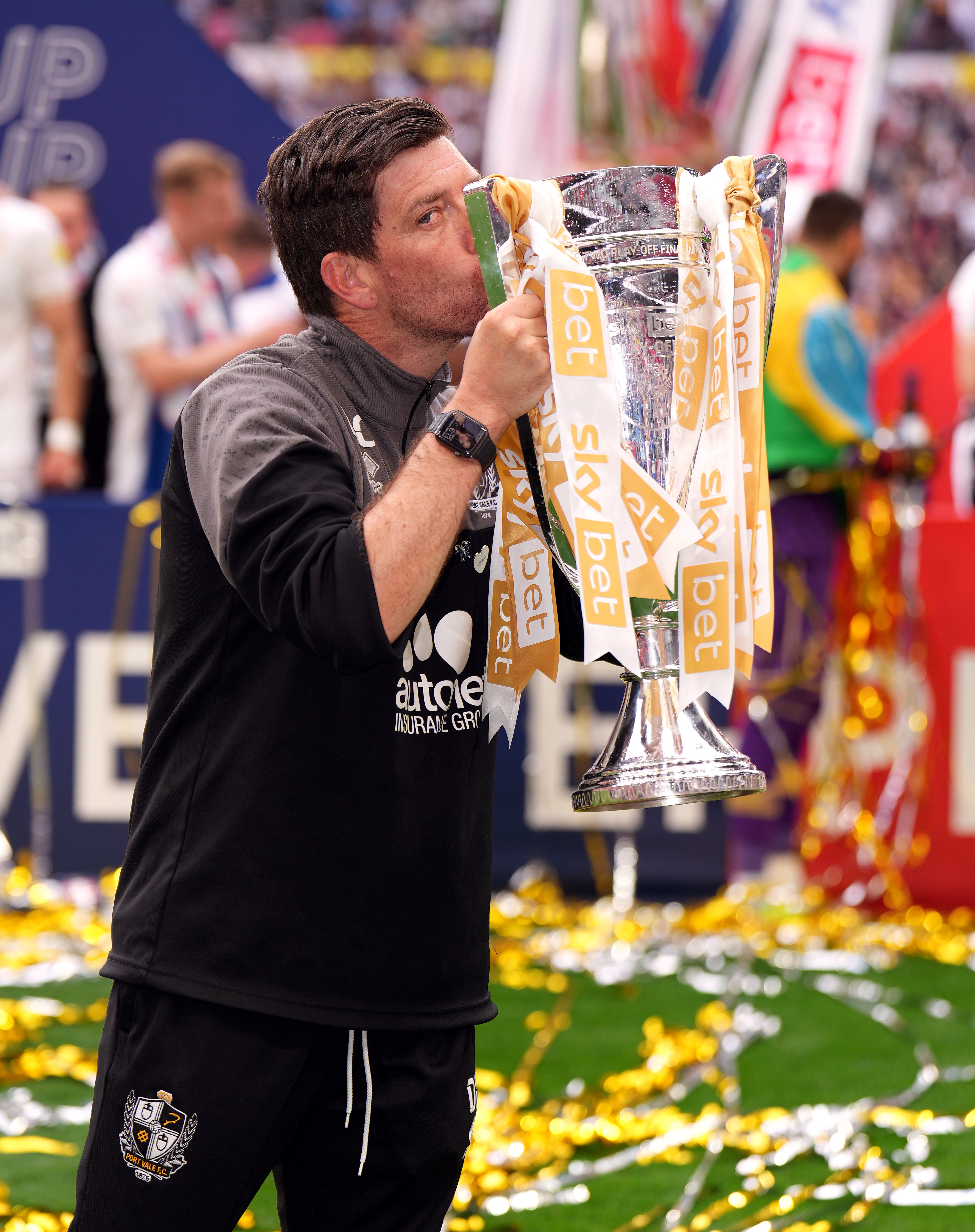Port Vale manager Darrell Clarke, back from compassionate leave, with the League Two play-off final trophy after his side’s 3-0 win over Mansfield at Wembley (John Walton/PA)
