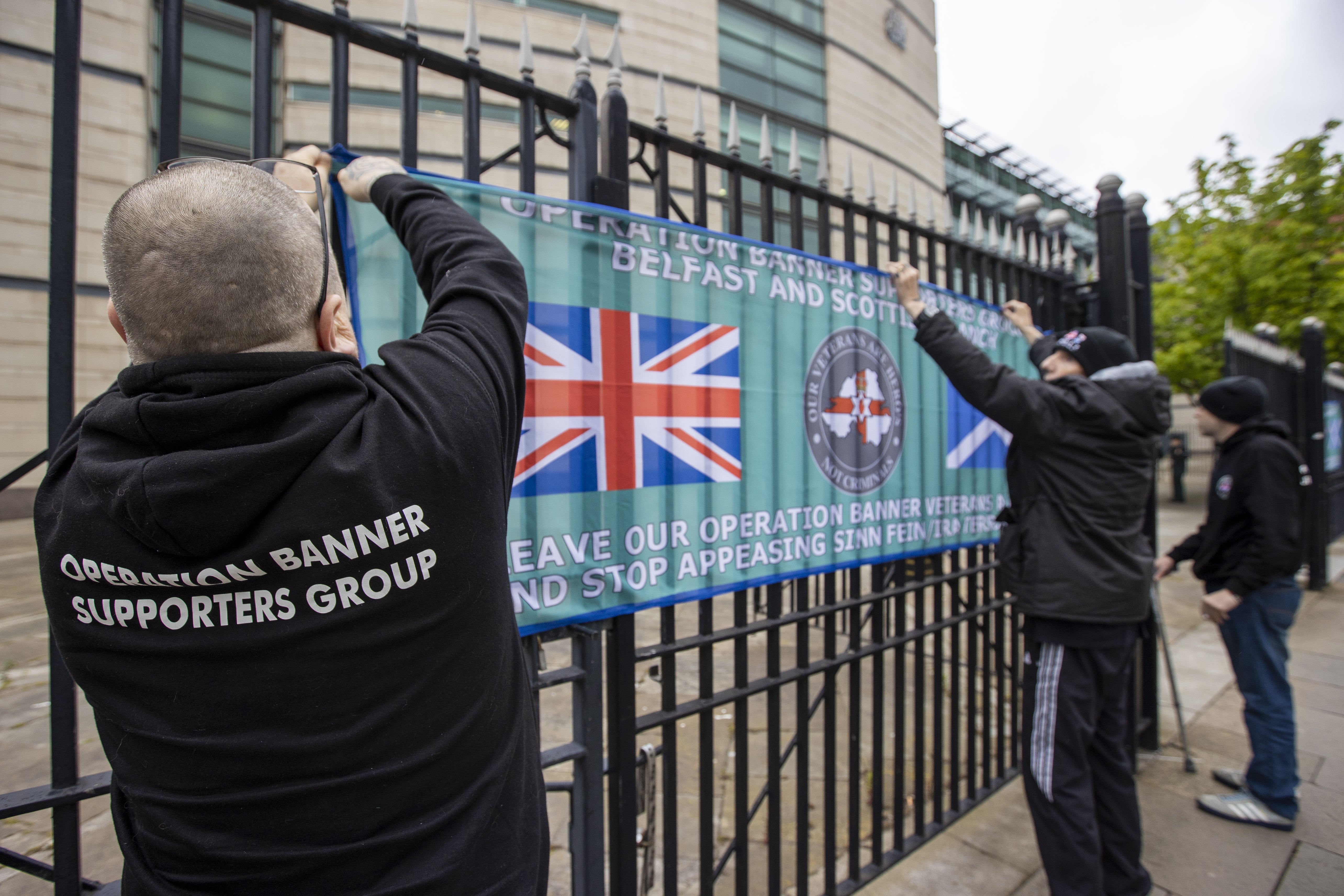 Operation Banner Supporters Group place banners on the gates of Laganside Court in Belfast (Liam McBurney/PA)