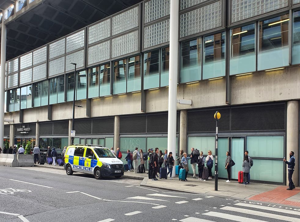 <p>Eurostar passengers waiting outside of the terminal building on Tuesday </p>