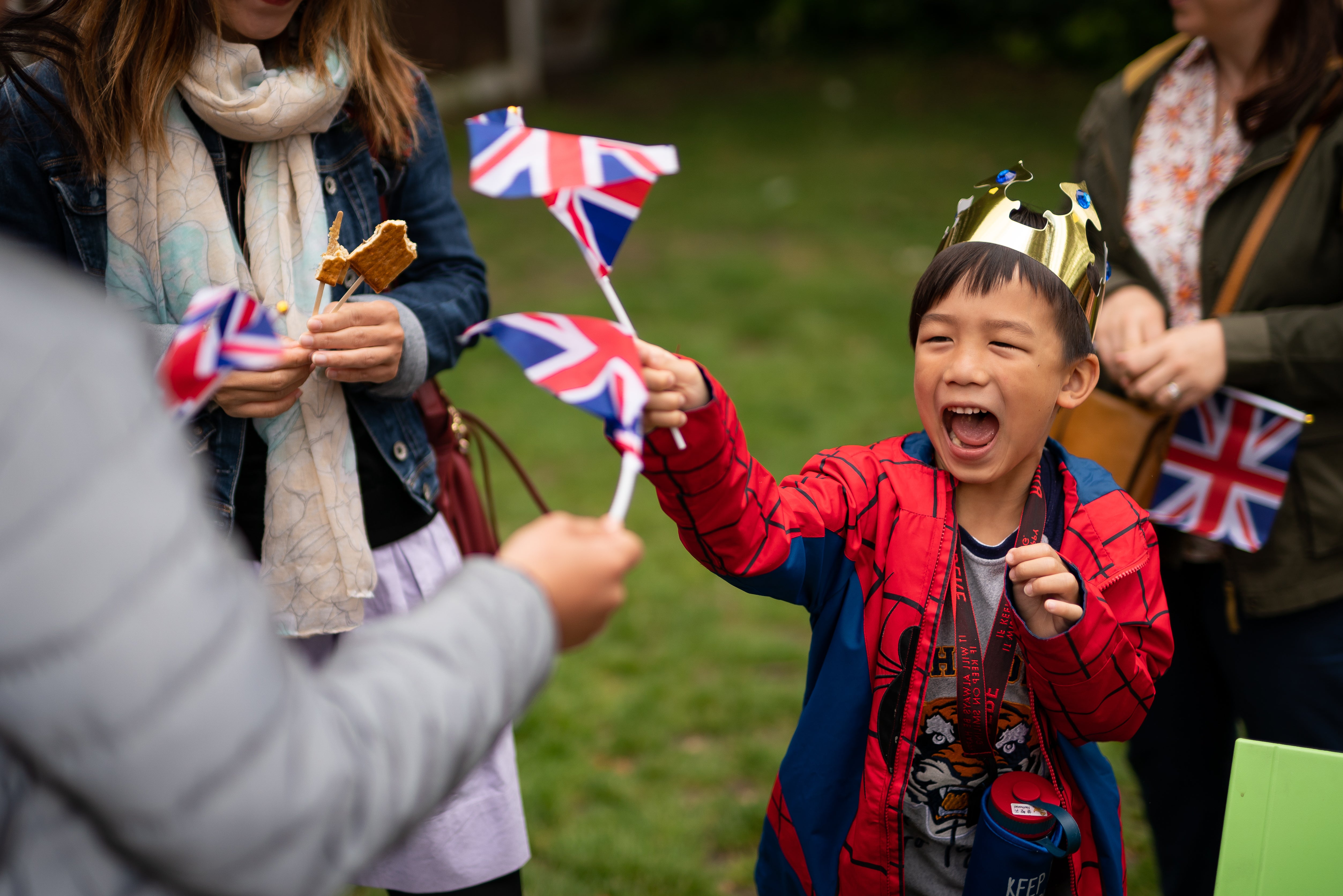 Newly arrived children from Hong Kong wave union flags (Aaron Chown/PA)
