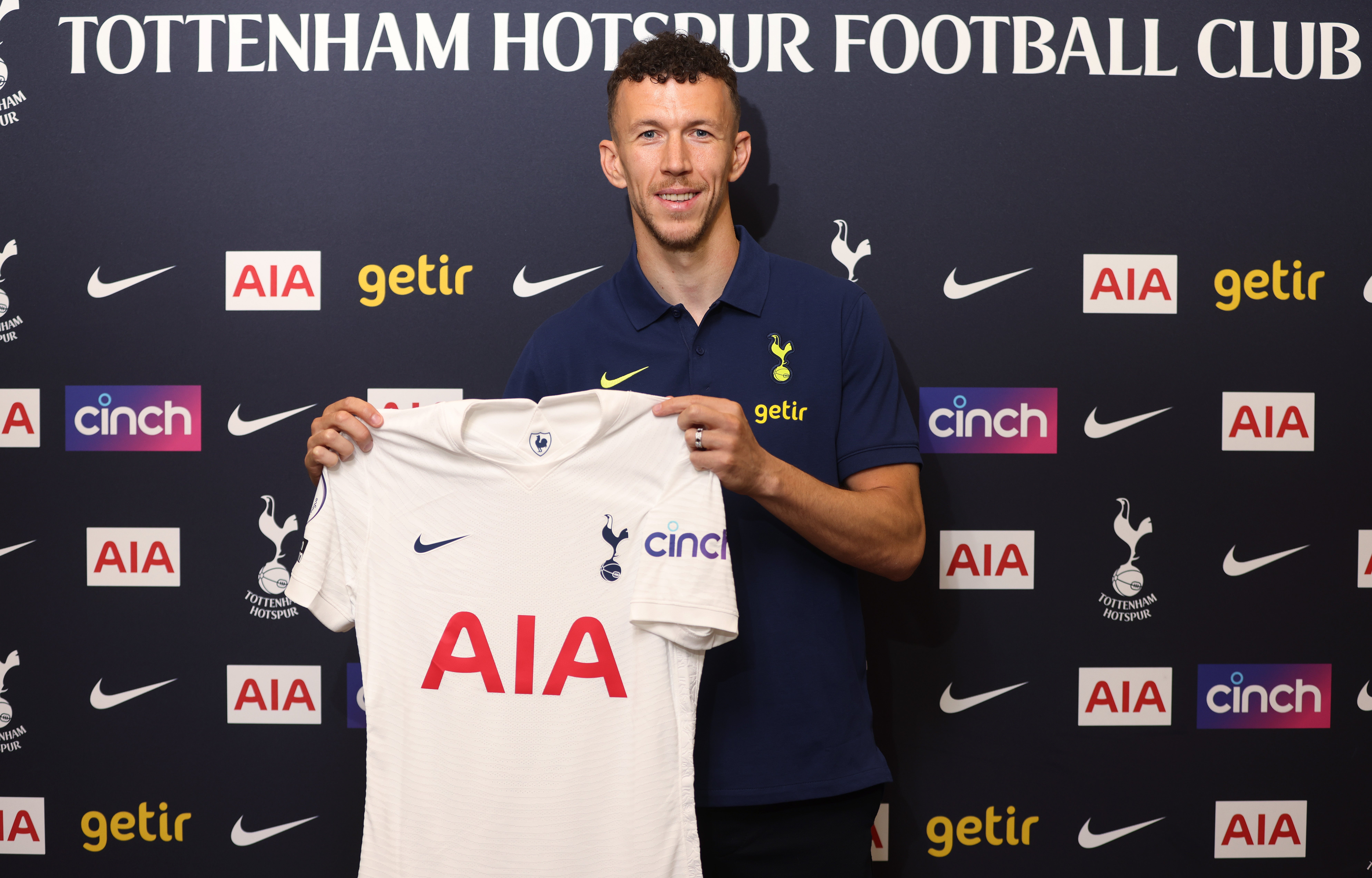 Ivan Perisic poses with the Tottenham shirt