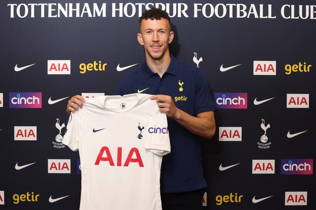 <p>Ivan Perisic poses with the Tottenham shirt</p>