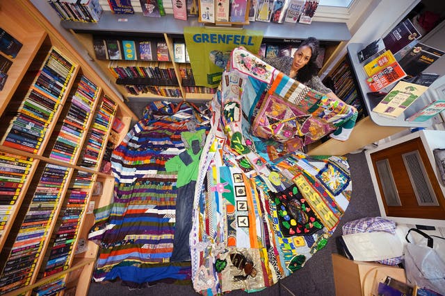 EMBARGOED TO 2230 WEDNESDAY JUNE 1 Artist Tuesday Greenidge, founder of the Grenfell Memorial Quilt Project, holding the work in progress, as Grenfell survivors, bereaved relatives and members of the wider community help to add to their 72-foot long memorial quilt, at North Kensington Library, ahead of the fifth anniversary of the Grenfell Tower fire which claimed 72 lives on June 14, 2017. Picture date: Tuesday May 31, 2022.