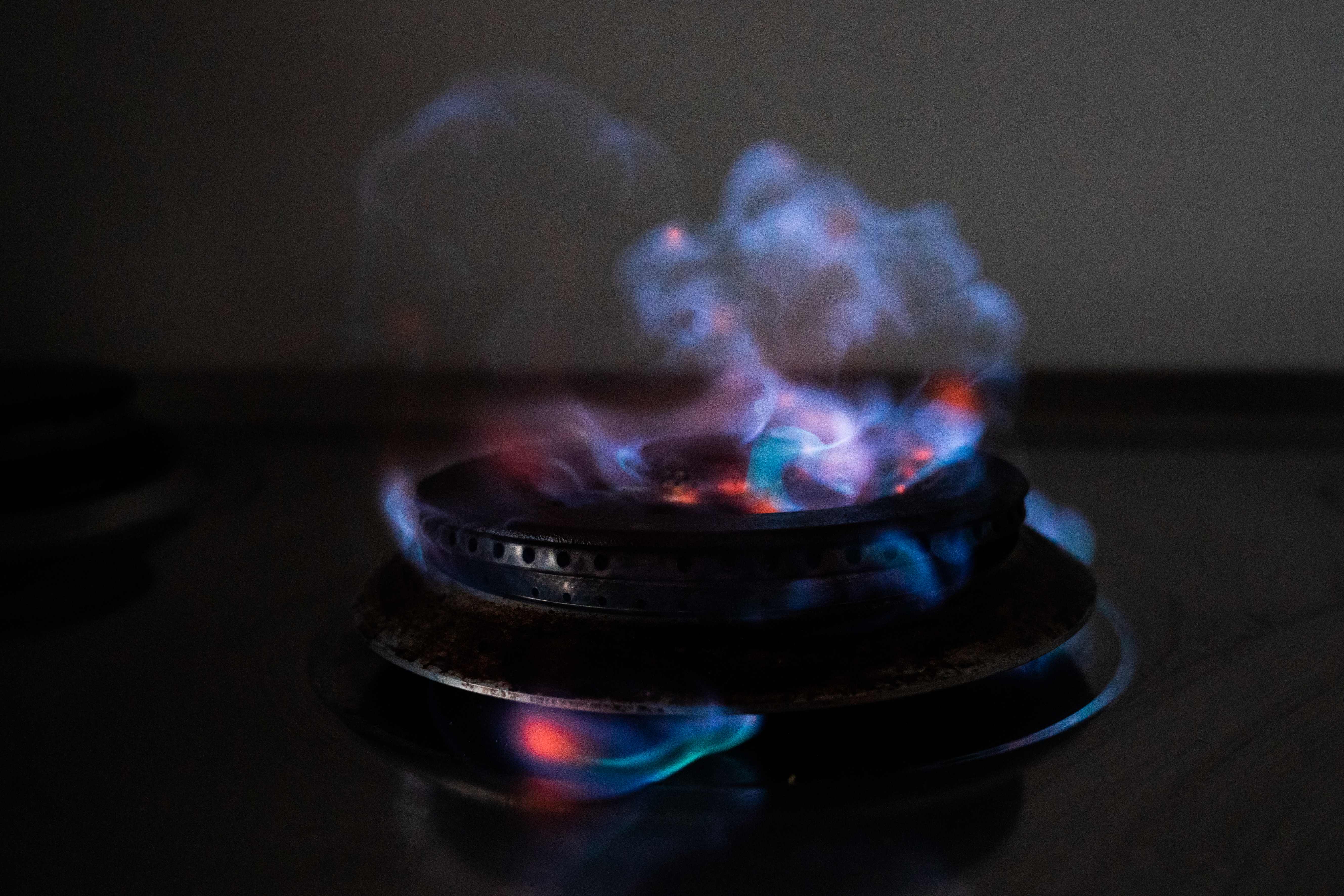 Blue and red gas flames on a kitchen gas stove are pictured in Copenhagen