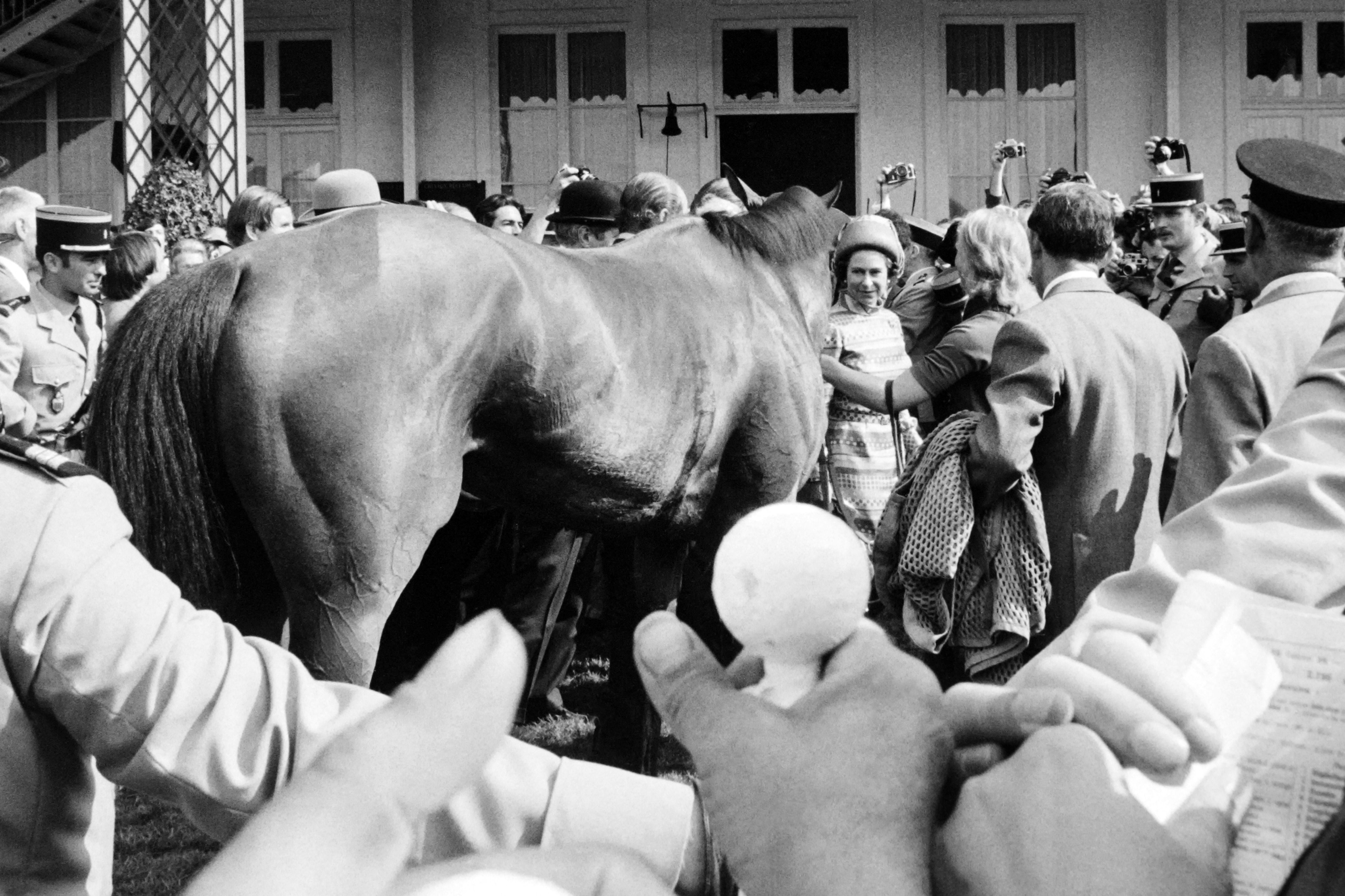 Greeting her victorious Highclere in the paddock after the Prix de Diane, on 6 June 1974 in Chantilly, France