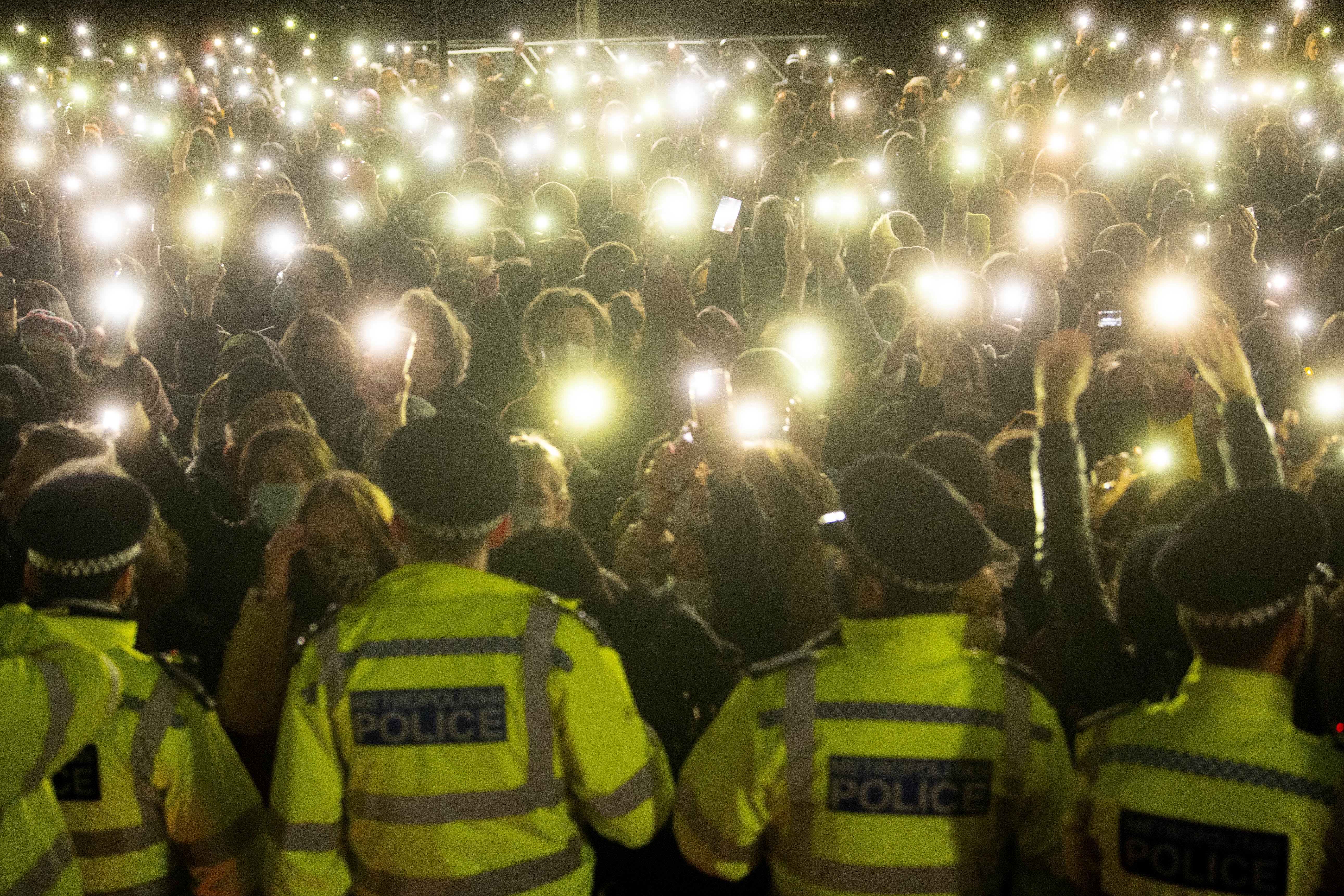 People in the crowd turning on their phone torches in Clapham Common, London, for a vigil for Sarah Everard (PA)