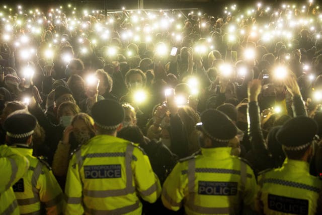 <p>People in the crowd turn on their phone torches in Clapham Common, London, for a vigil for Sarah Everard, on 13 March 2021 </p>