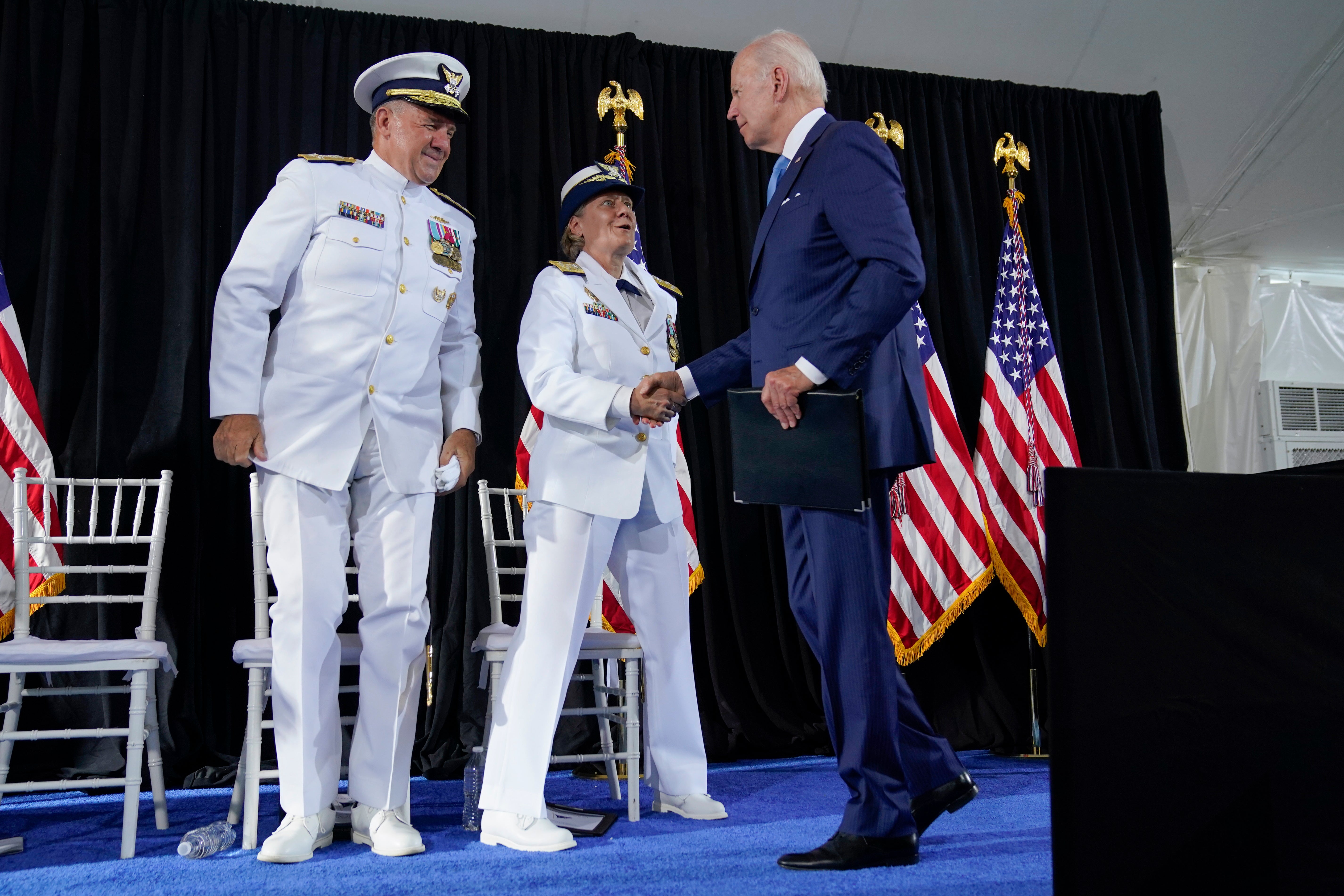 President Joe Biden shakes hands with Adm. Linda Fagan after speaking during a change of command ceremony at U.S. Coast Guard headquarters, Wednesday, June 1, 2022, in Washington. Adm. Karl L. Schultz is being relieved by Adm. Linda Fagan as the Commandant of the U.S. Coast Guard. (AP Photo/Evan Vucci)