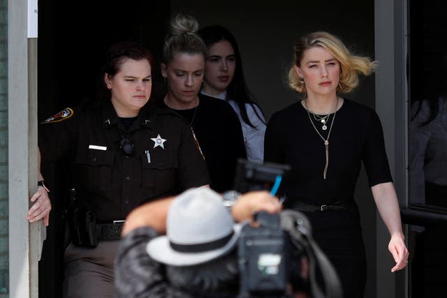 <p>Amber Heard leaves Fairfax County Circuit Courthouse after the jury announced split verdicts in favor of both her ex-husband Johnny Depp and Heard on their claim and counter-claim in the Depp v. Heard civil defamation trial at the Fairfax County Circuit Courthouse in Fairfax, Virginia</p>