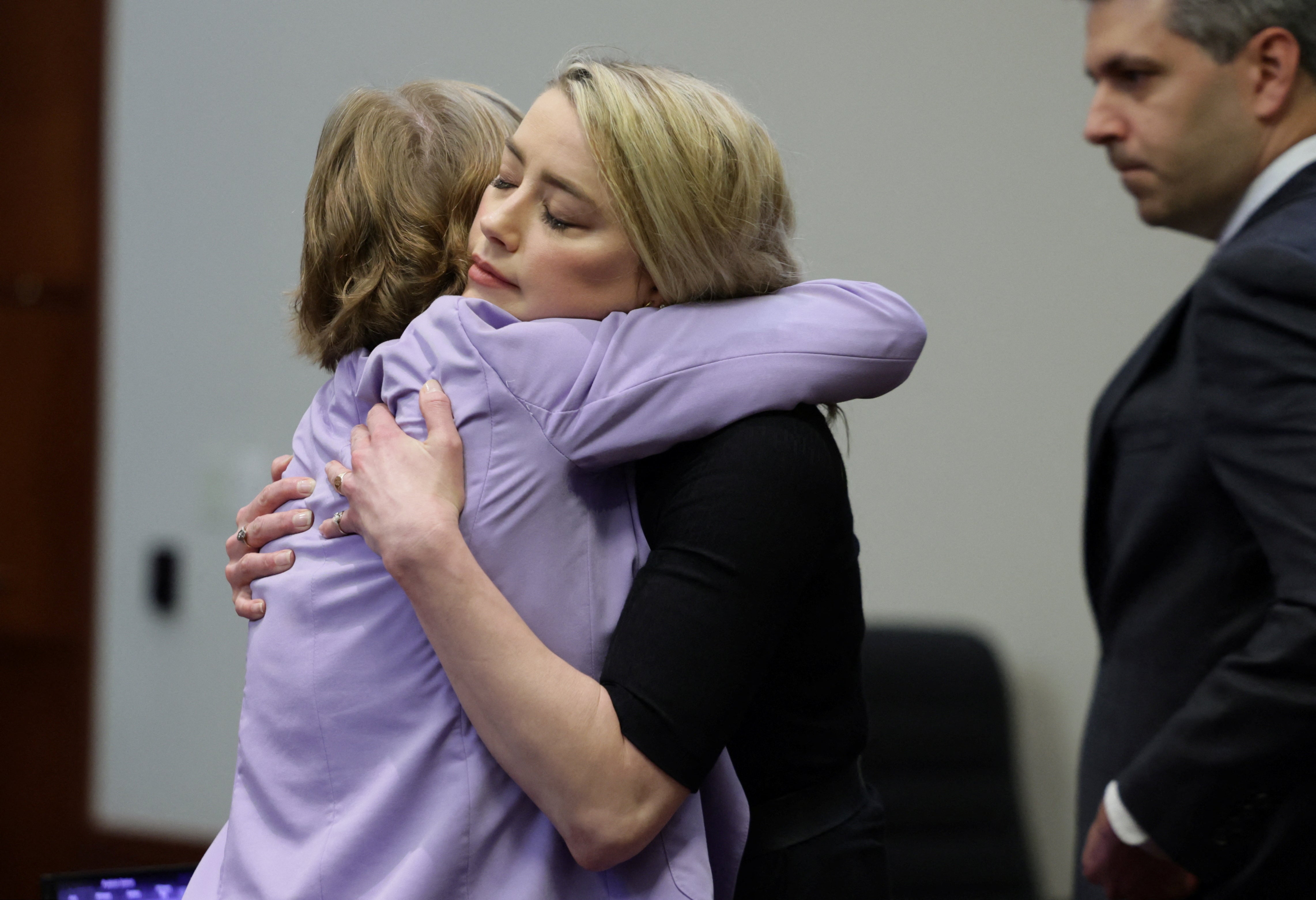 Actor Amber Heard hugs her lawyer Elaine Bredehoft after the jury said that they believe she defamed ex-husband Johnny Depp