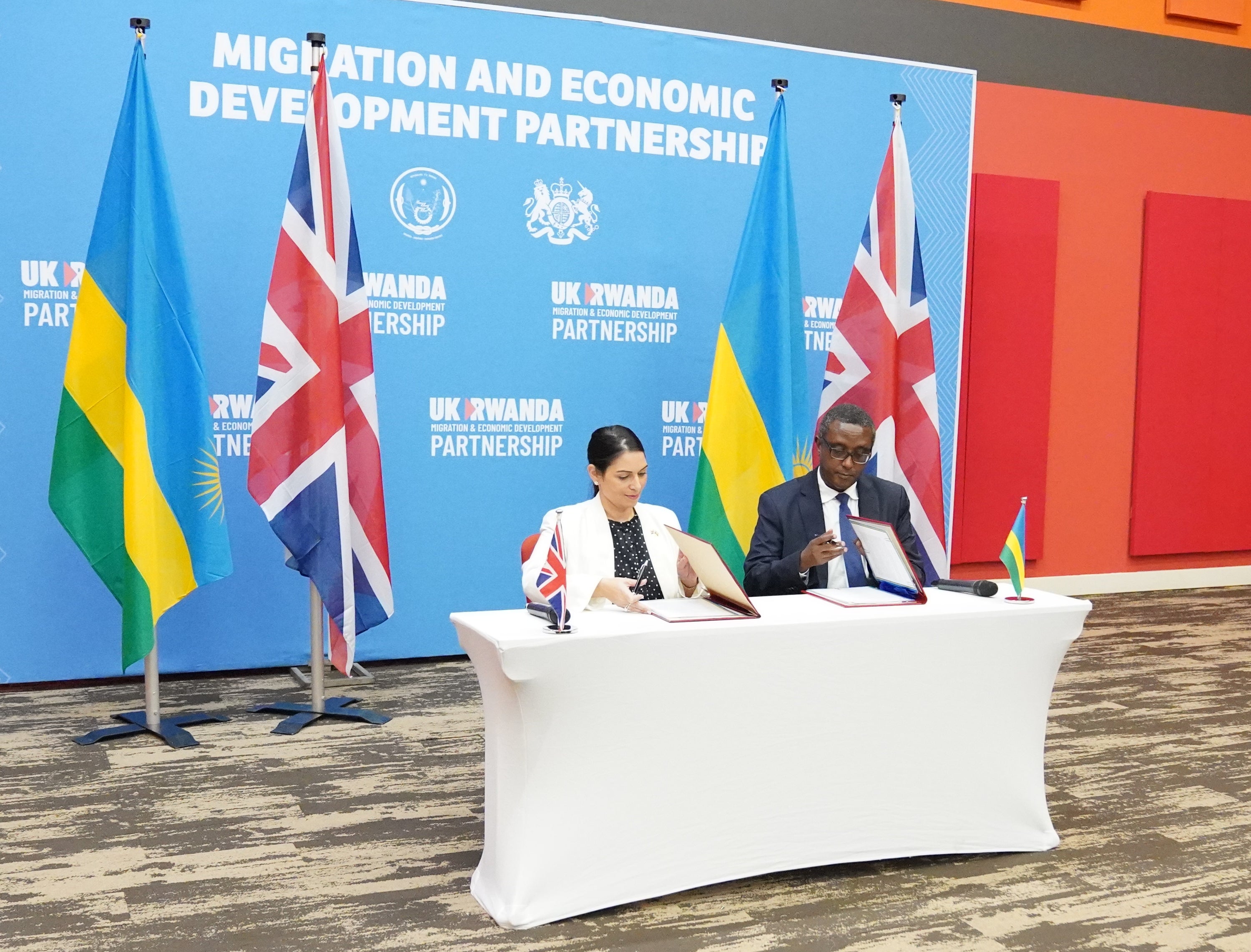 Priti Patel signing the deportation agreement in Rwanda