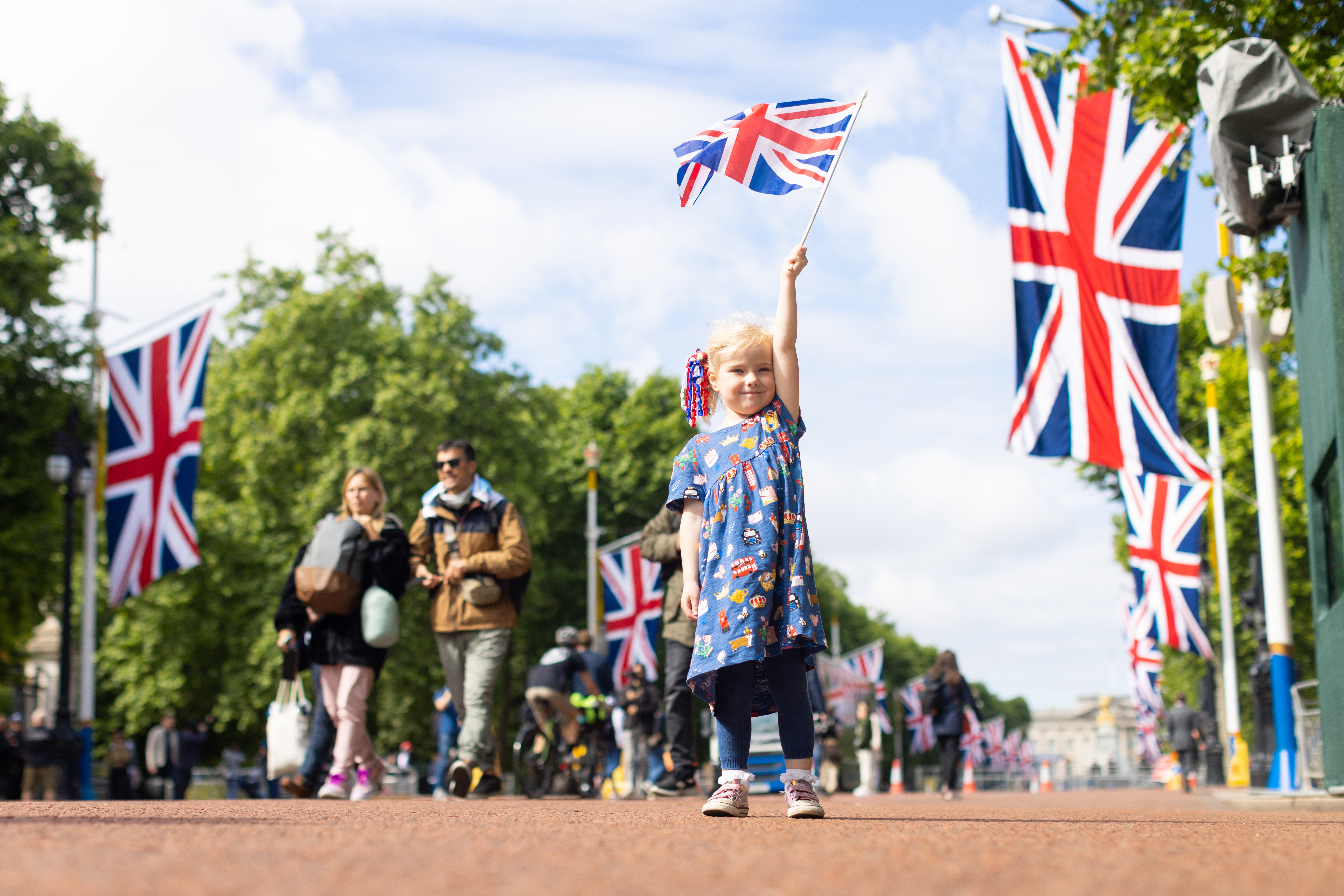 Drew, aged four, from Norwich, waves her Union flag on The Mall during a family day trip ahead of the Platinum Jubilee celebrations (James Manning/PA)