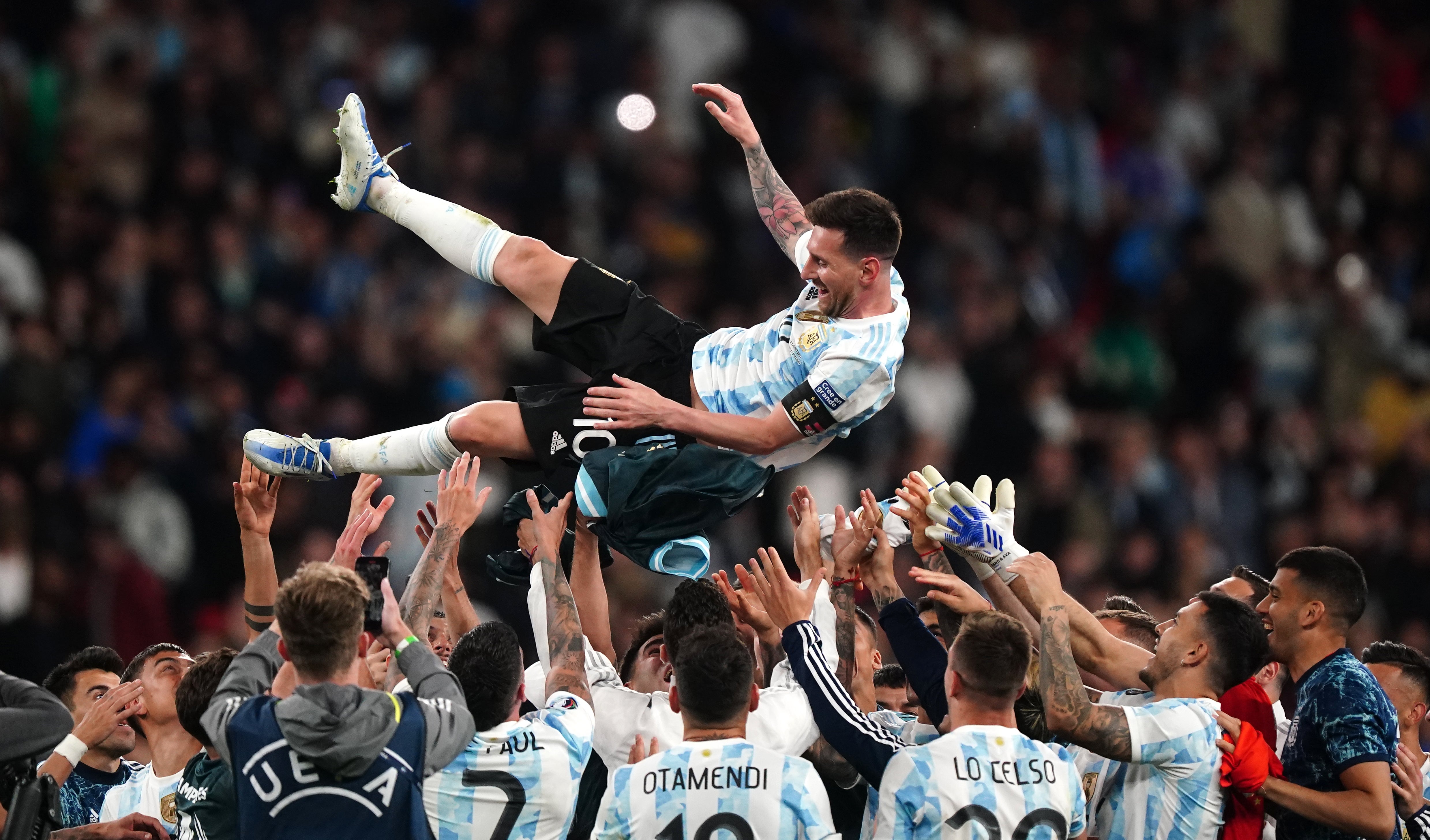 Argentina throw Lionel Messi in the air (Mike Egerton/PA)