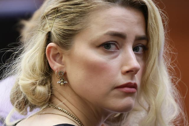 <p>Amber Heard listens to the verdict  </p>