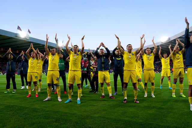 <p>Ukraine players applaud the fans at Hampden Park</p>