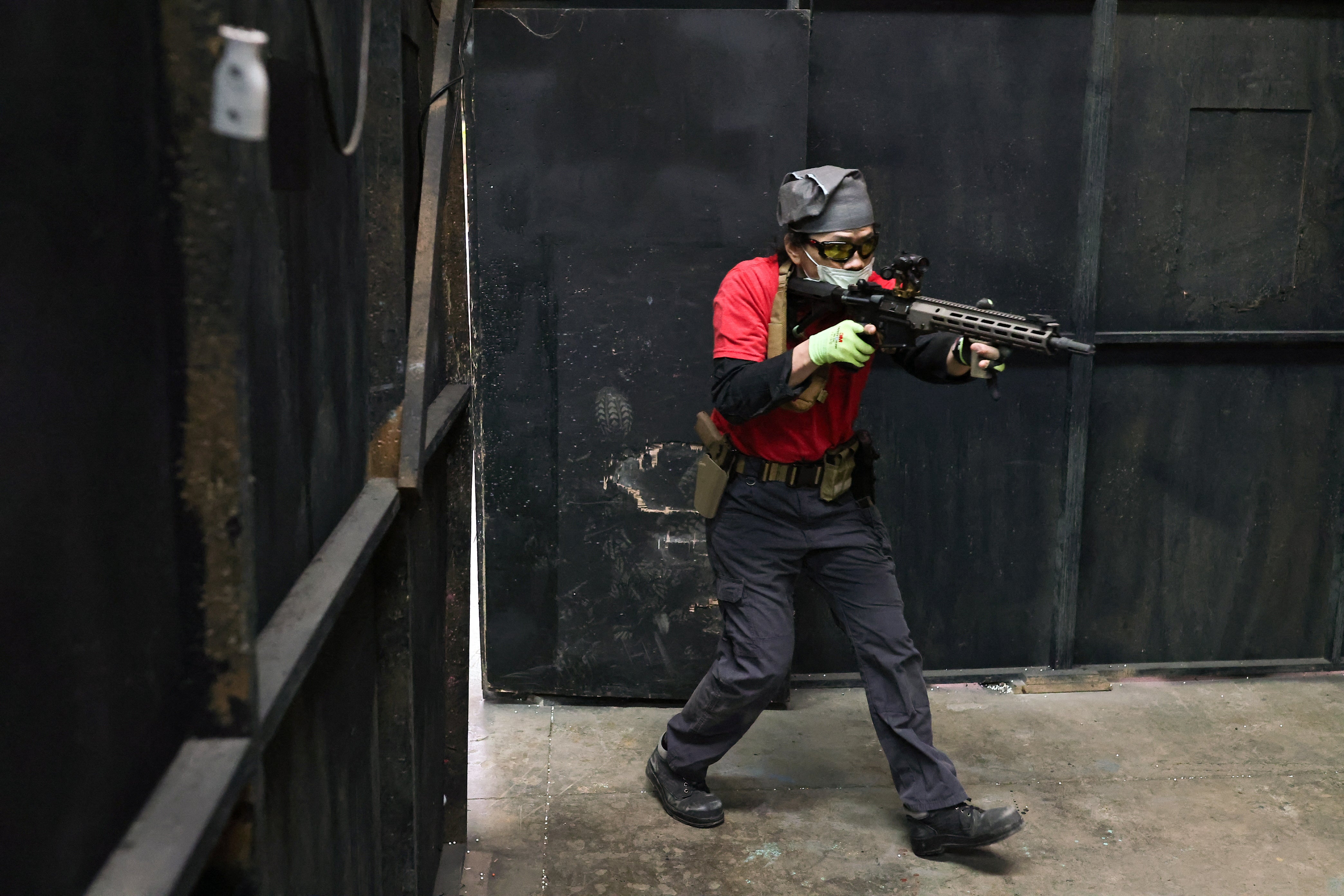 A trainee practises entering a building with his airsoft gun
