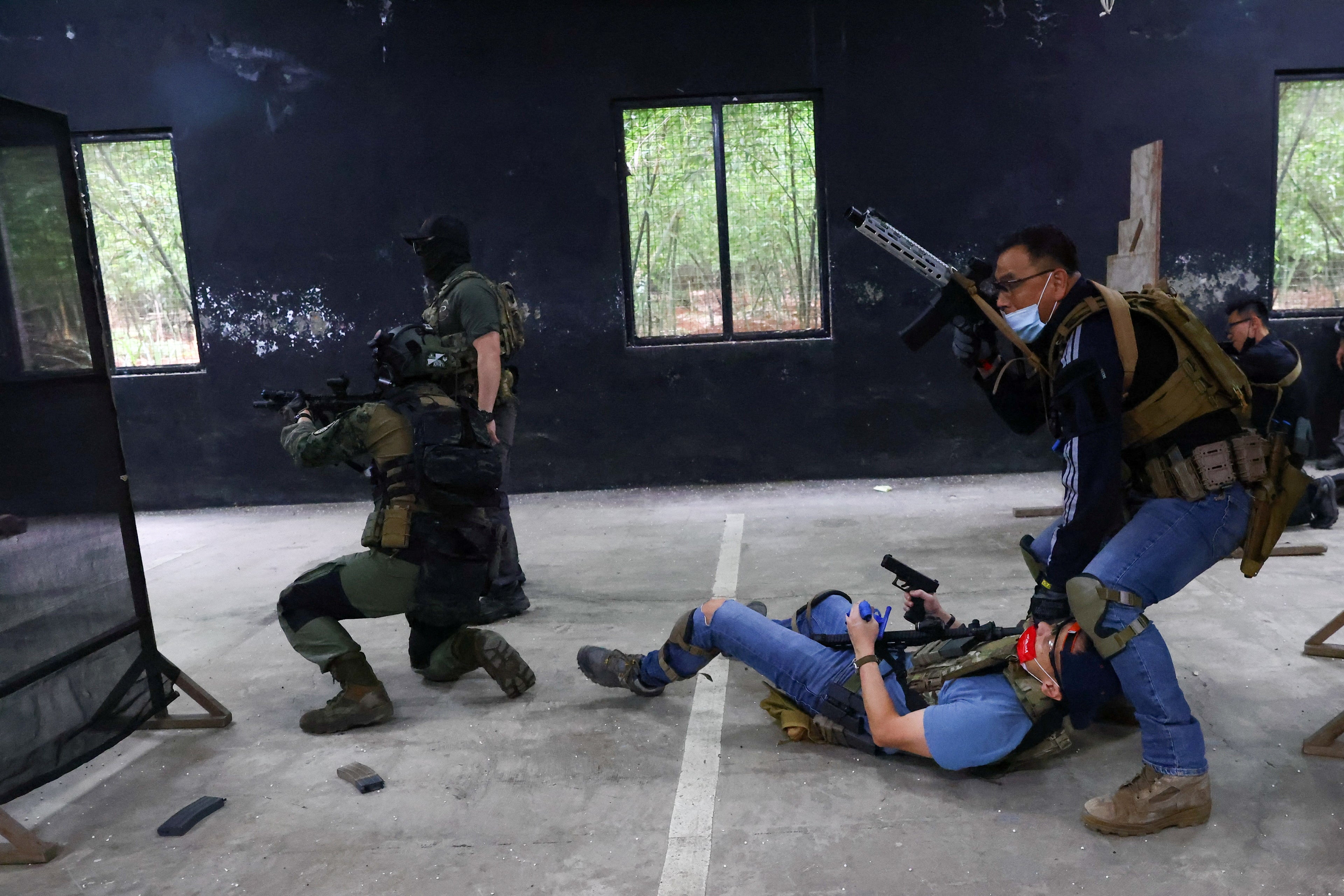 Trainees work on a simulated hostage rescue mission during an airsoft gun training lesson