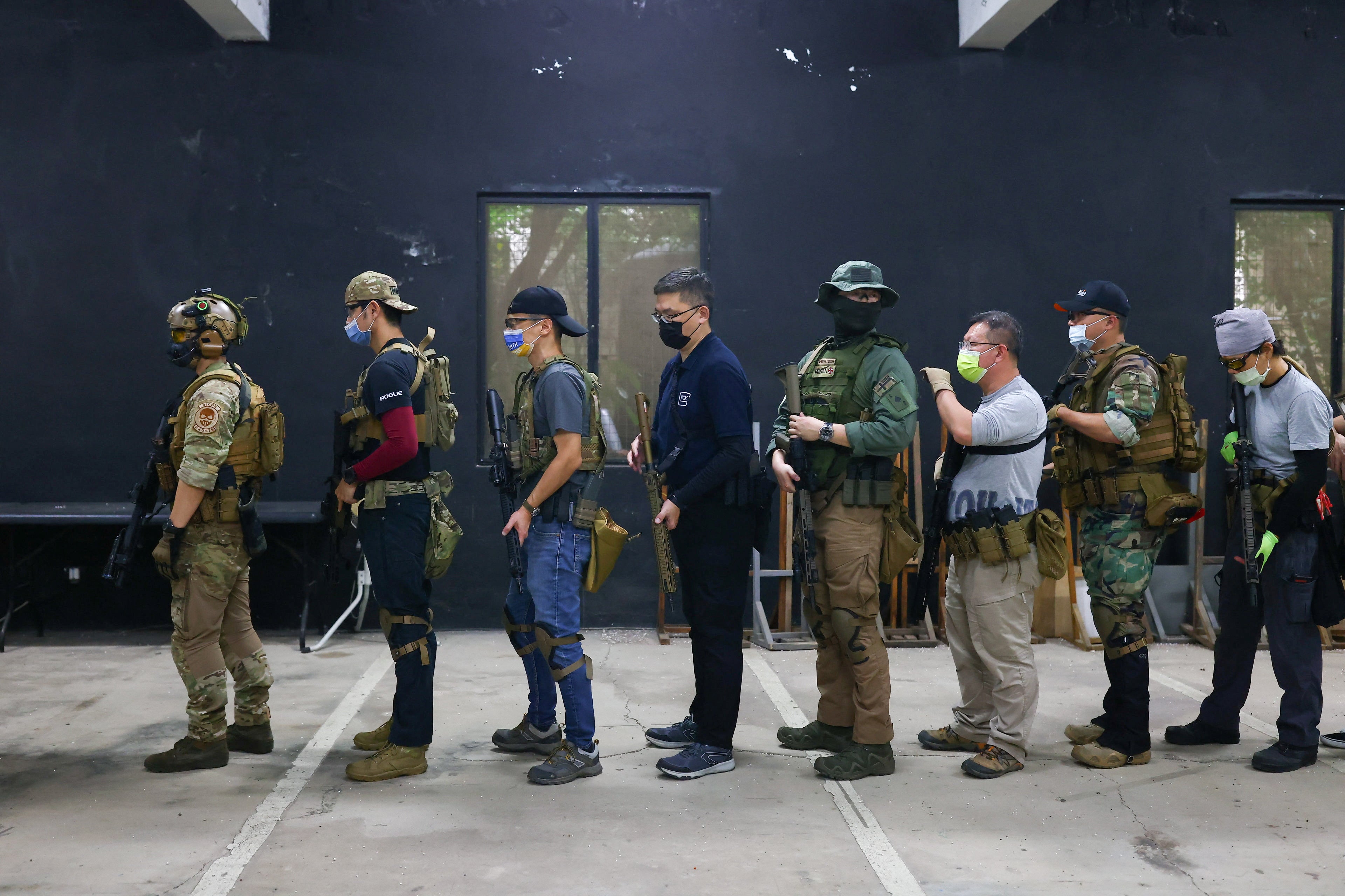Trainees line up to practise target shooting