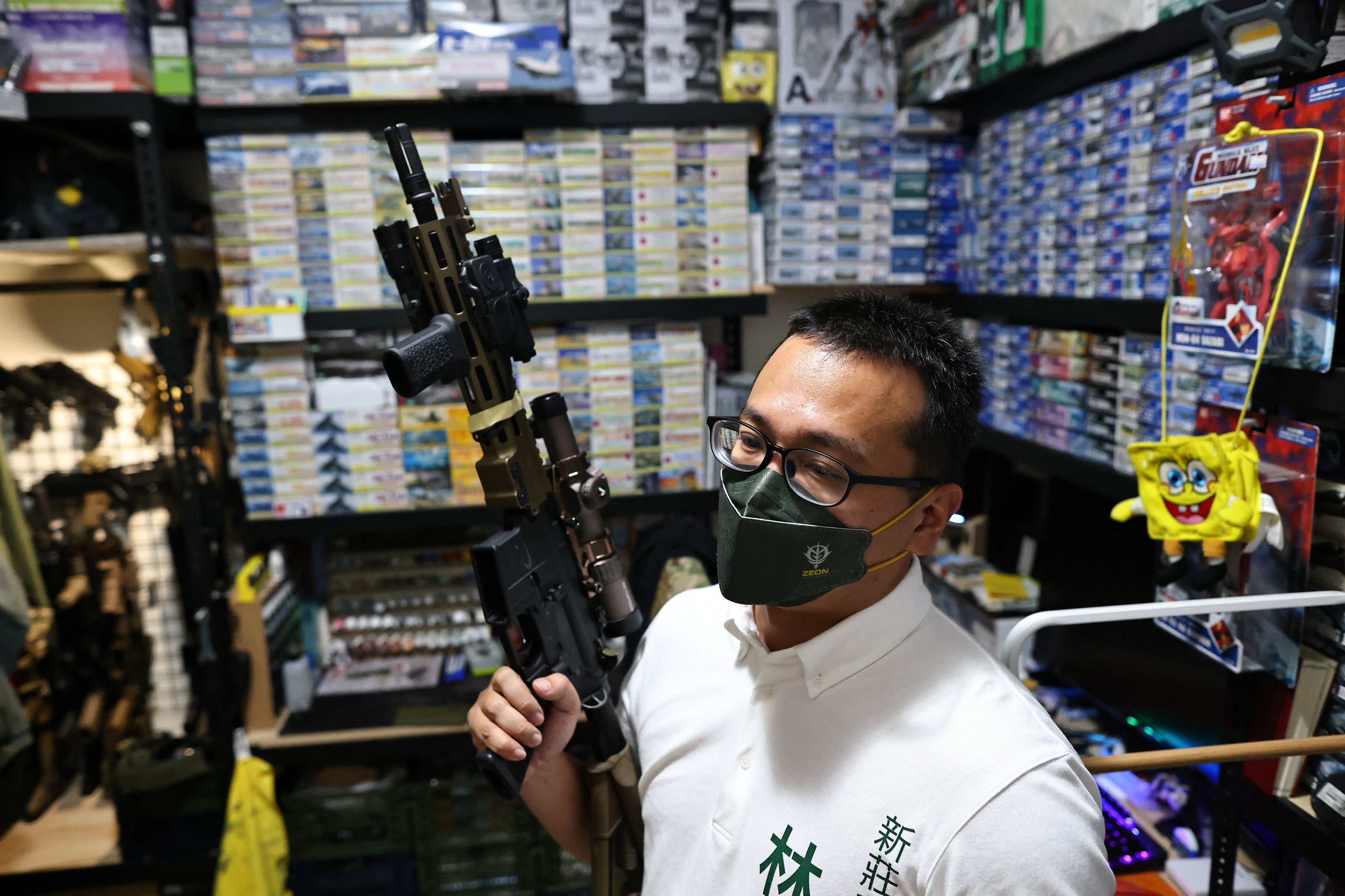 Lin Ping-yu, a politician for the ruling Democratic Progressive Party who is competing for a seat in the local council, displays of one of his 12 airsoft guns at his home in New Taipei City