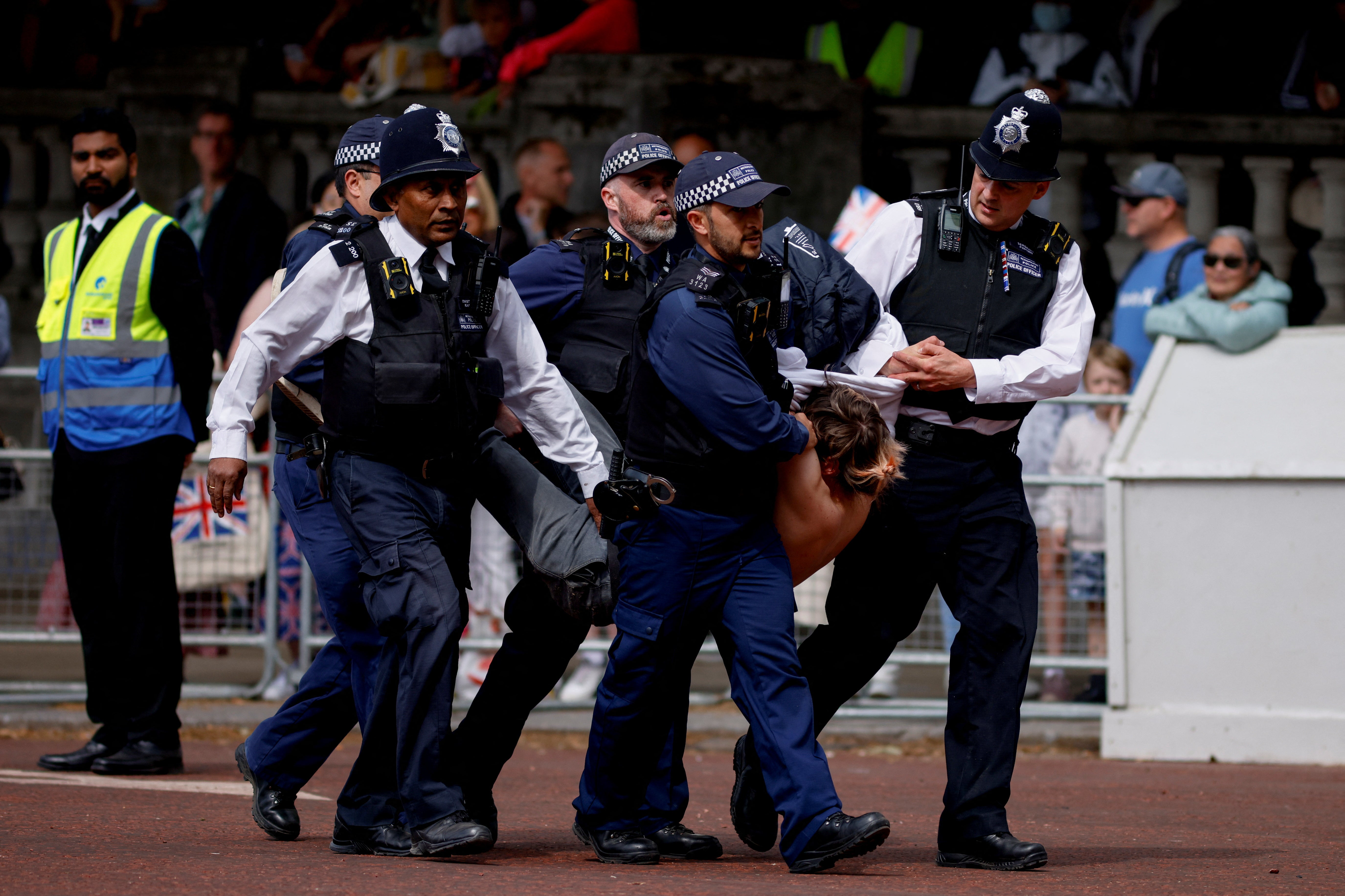 Police officers detain a protester who tried to disrupt the ceremony during the Queen's Platinum Jubilee celebrations