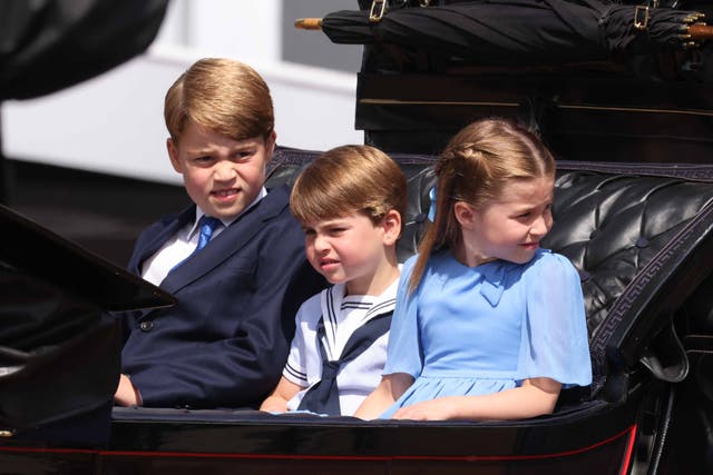 Prince George, Prince Louis and Princess Charlotte ride in a carriage as the Royal Procession leaves Buckingham Palace for the Trooping the Colour ceremony (Ian Vogler/Daily Mirror/PA)
