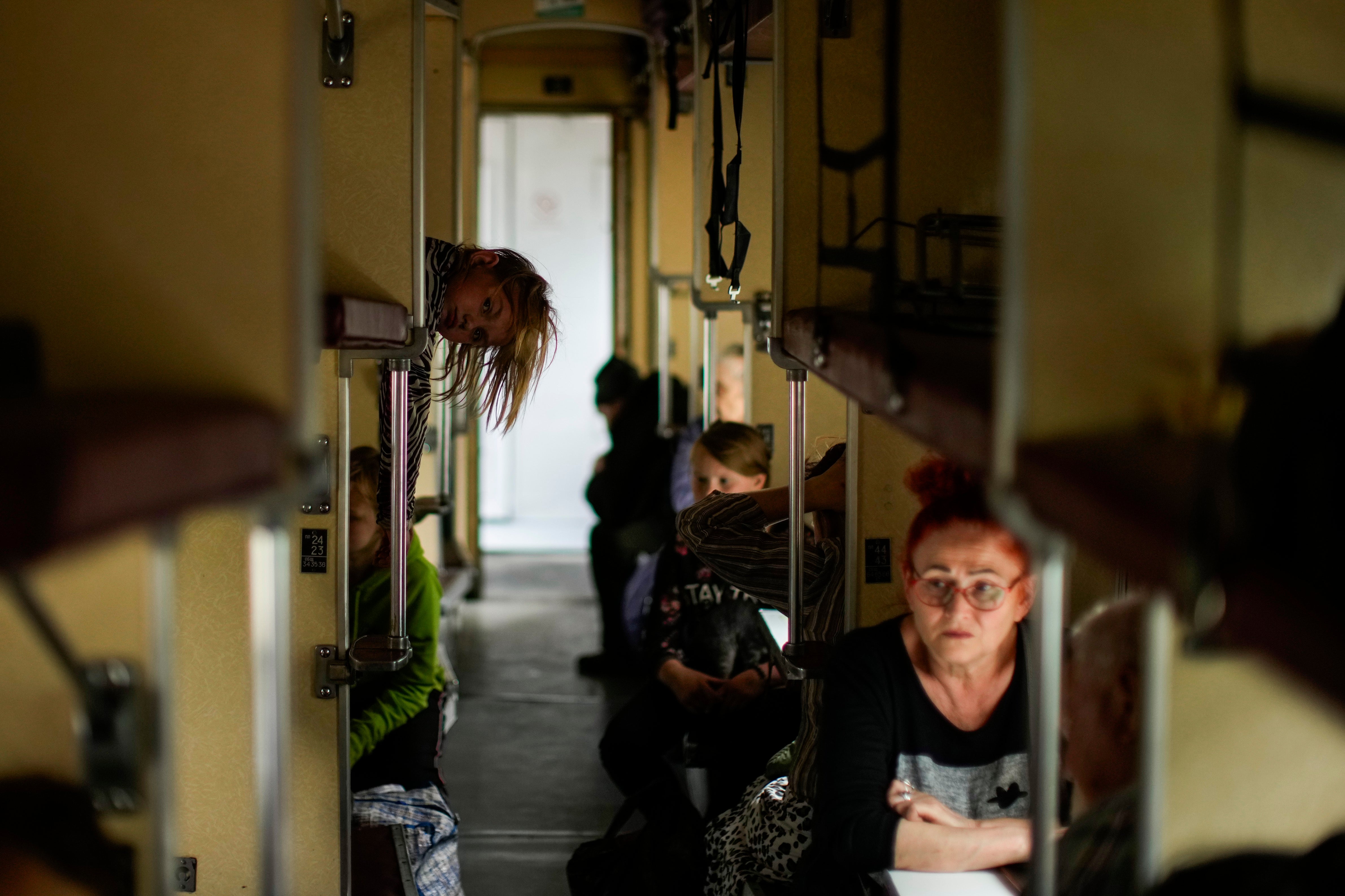 People fleeing from Lysychansk and other areas sit in an evacuation train at the train station in Pokrovsk