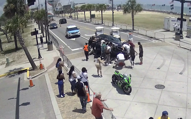 <p>Officers and bystanders in Myrtle Beach who saw a motorcyclist get pinned under a car rush to rescue the man by working together to lift the vehicle off his body.</p>